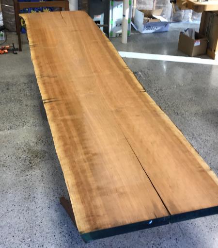 A rough cherry plank 12 feet long and 18 inches wide